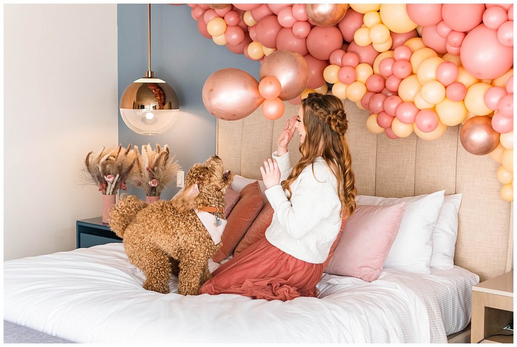 Girl and dog on bed on valentine's day