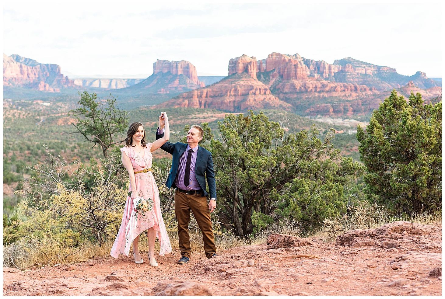 Couple dancing on cliff edge after getting engaged in Sedona, Arizona
