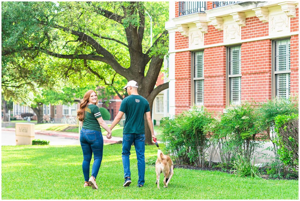 man and woman walking dog on Baylor University campus