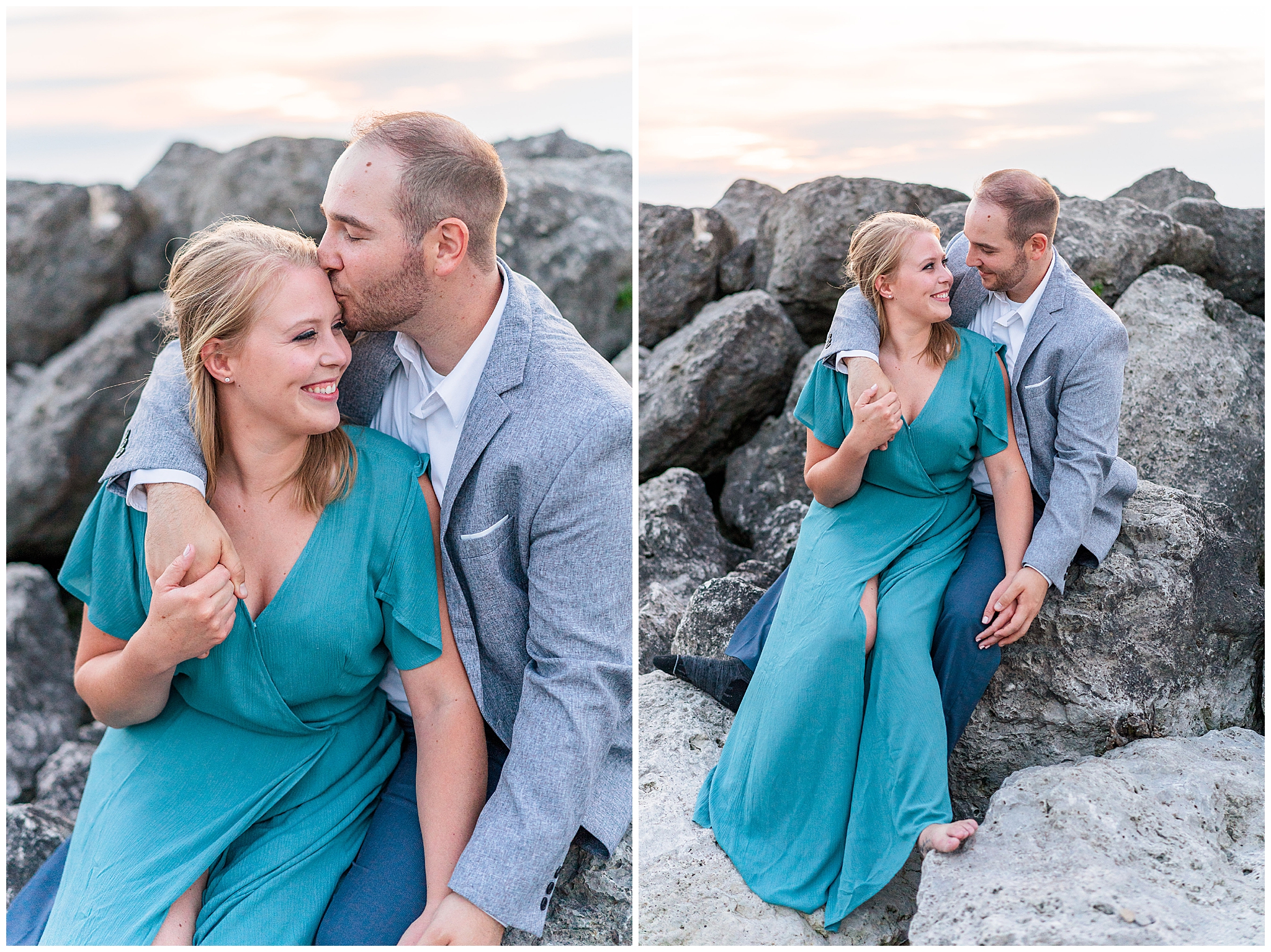 Romantic formal engagement portraits at Sims Park beach in Cleveland Ohio. Woman is wearing a long formal teal gown with flowing sleeves. The man is in a grey suit and white button up shirt. They are looking in each other's eyes and sitting on rock formations on the shore. 