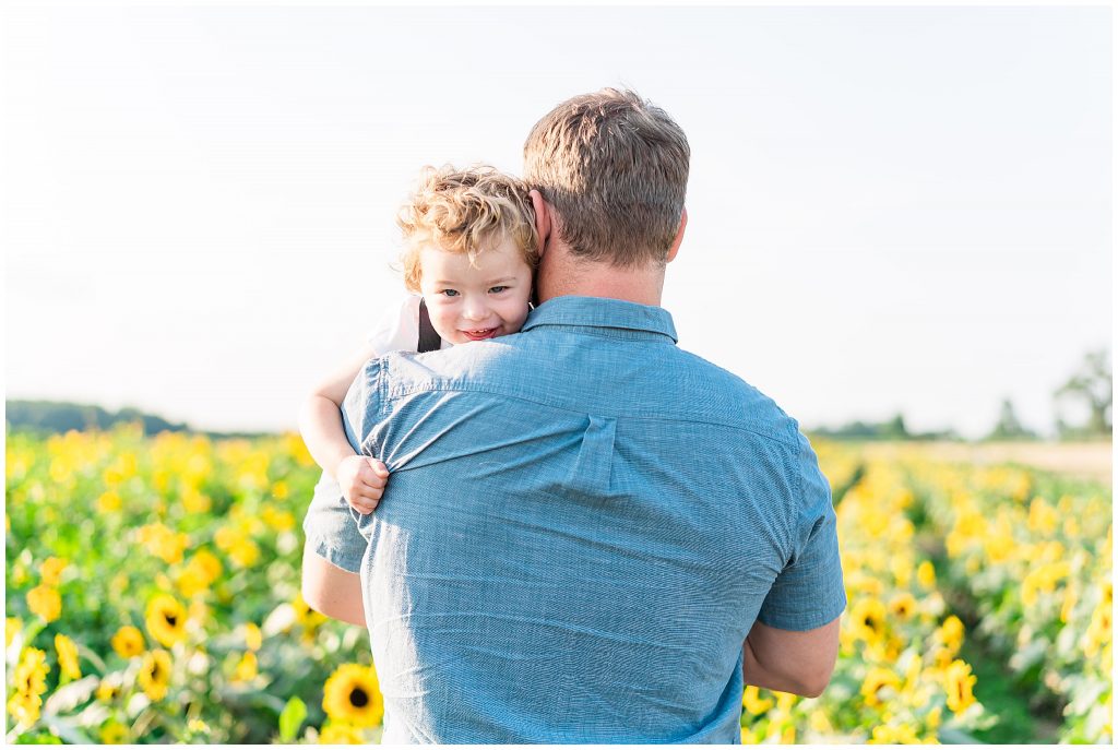 little boy and dad in sunflower field