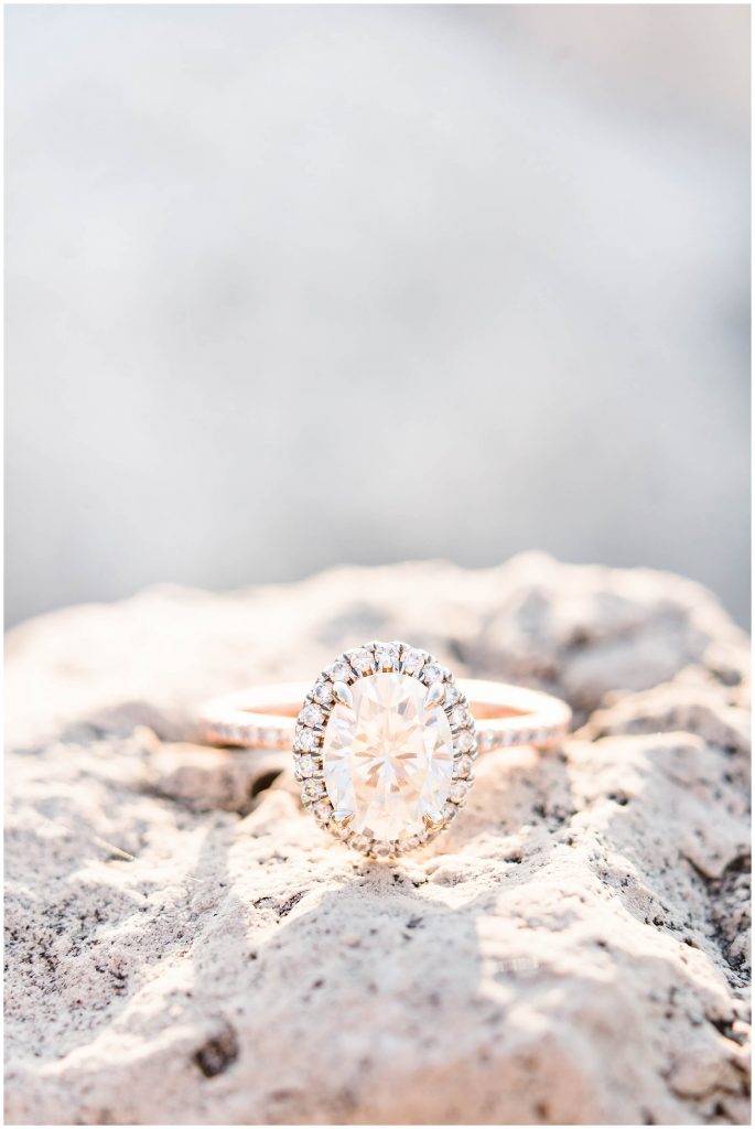oval diamond engagement ring on rock at beach at Maumee Bay State Park beach